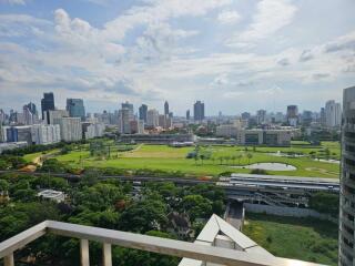 View from balcony overlooking cityscape and green park