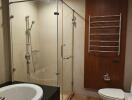 Modern bathroom with glass shower enclosure and bathtub