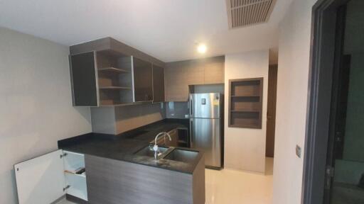 Modern kitchen with stainless steel appliances and dark countertops