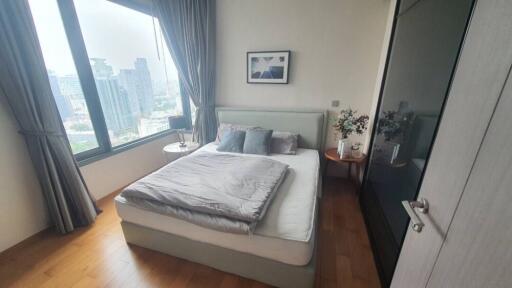 Spacious and well-lit bedroom with a scenic city view