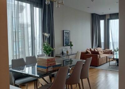 Living room with dining area and large windows