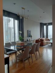 Living room with dining area and large windows