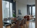 Living room with dining area and large windows