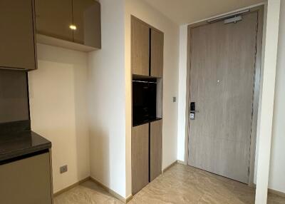 Modern apartment entrance with tiled flooring and built-in cabinets