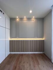 Bedroom with wooden flooring and modern wall design