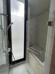 Modern bathroom with shower and frosted window