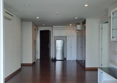 Spacious living area with hardwood floors and built-in shelves