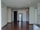 Spacious living area with hardwood floors and built-in shelves