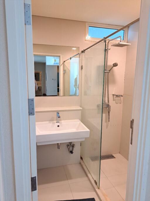 Modern bathroom with glass shower enclosure and white sink