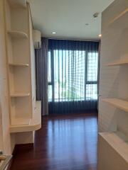 Modern bedroom with built-in shelves and large window