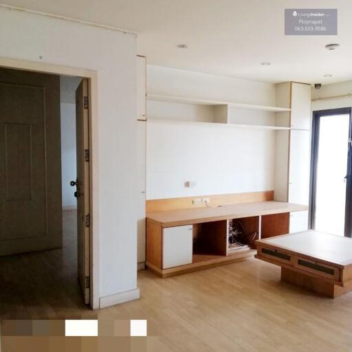 Spacious living room with built-in shelves and a wooden table