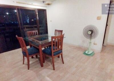 Dining area with glass table and wooden chairs