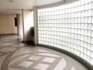 Spacious and well-lit hallway with unique glass block wall and modern design