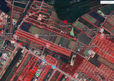 Aerial view of a residential and commercial area with plotted boundaries.