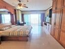 Spacious bedroom with large wooden wardrobe and balcony