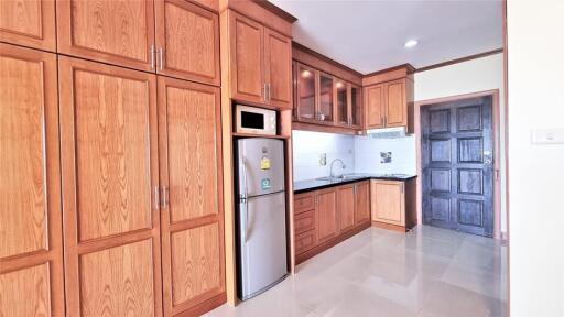 Modern kitchen with wooden cabinetry and stainless steel appliances