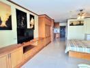 Spacious master bedroom with wooden cabinetry and integrated entertainment system