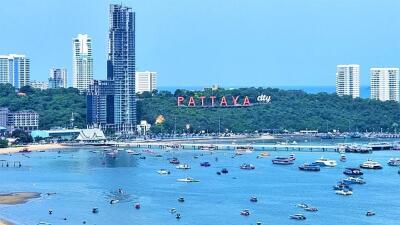 Scenic view of Pattaya city coastline with buildings and boats