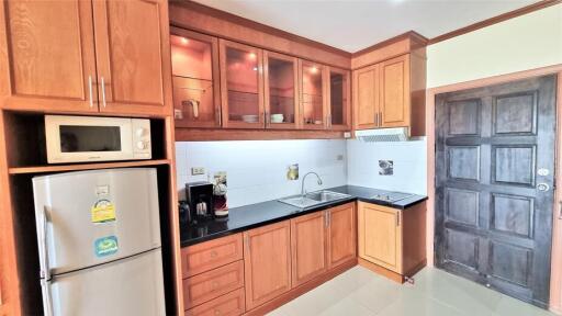 Modern kitchen with wooden cabinetry and appliances