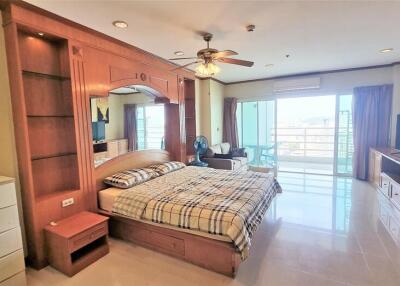 Spacious bedroom with large windows and balcony access