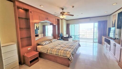 Spacious bedroom with large windows and balcony access