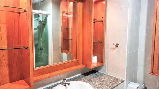 Modern bathroom with wooden accents and large mirror