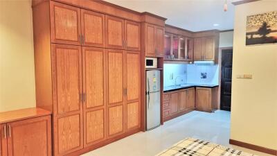 Wood-finished kitchen with cabinets and stainless steel appliances