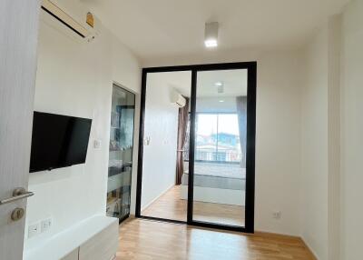 Modern living room with a wooden floor and a glass partition