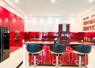 Modern kitchen with red and white cabinetry and black countertops