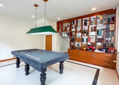 Spacious area featuring a pool table and built-in shelving