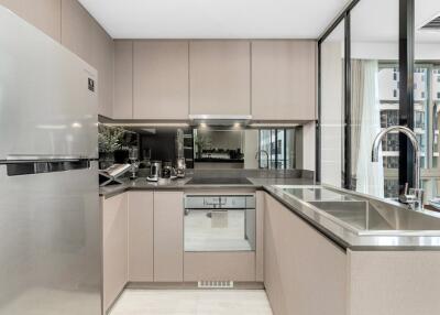 Modern kitchen with stainless steel appliances and large windows