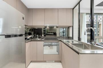 Modern kitchen with stainless steel appliances and large windows