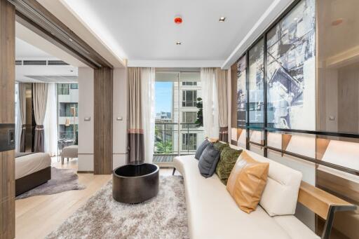 Modern living room with adjacent bedroom and balcony