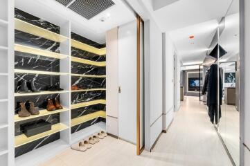 Spacious walk-in closet with wooden shelves and ample storage