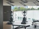 Modern gym with exercise equipment including elliptical machines and free weights