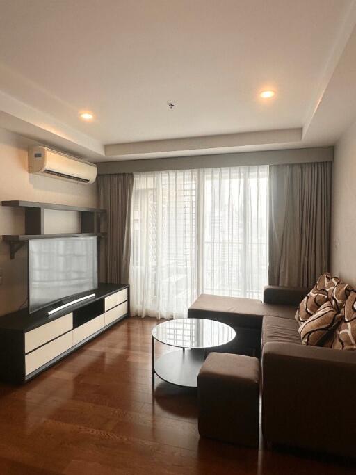 Modern living room with brown sofa and entertainment center