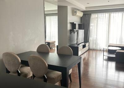 Modern open-plan living area with dining table and entertainment unit