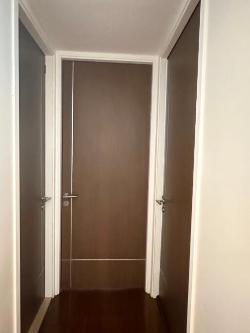 A modern hallway with three closed doors