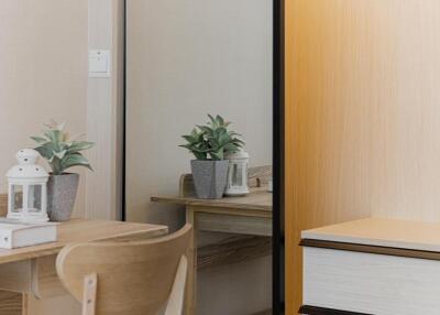 Bedroom workspace with desk, chair, and potted plants