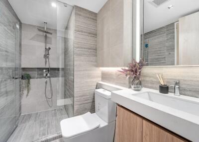 Modern bathroom with glass shower and marble finishes