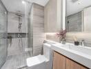 Modern bathroom with glass shower and marble finishes