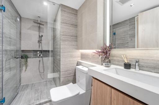 Modern bathroom with glass shower and marble finishes