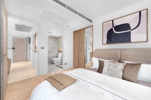 Modern bedroom with a view into the bathroom, showcasing stylish decor