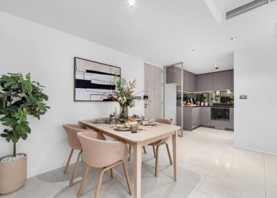 Modern dining area with a set table and artwork on the wall