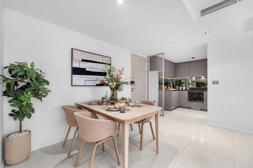 Modern dining area with a set table and artwork on the wall