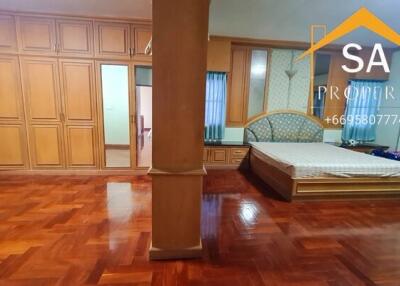 Bedroom with wooden floors and built-in wardrobes