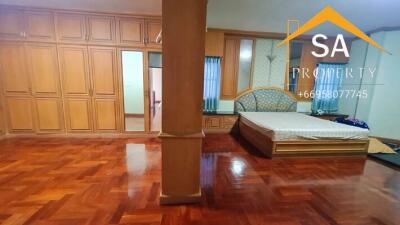 Bedroom with wooden floors and built-in wardrobes