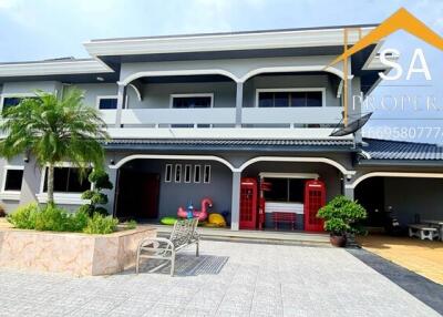 Front view of a modern two-story house with a landscaped yard