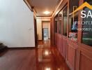 A polished wooden hallway with storage cabinets