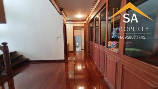 A polished wooden hallway with storage cabinets